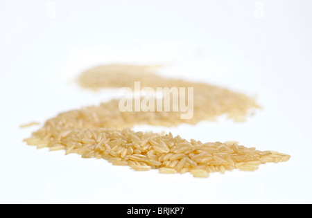 Heap of brown rice on white background Stock Photo