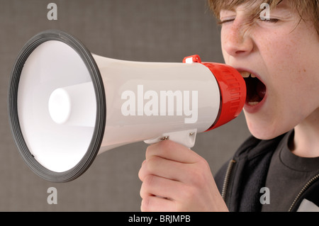 Boy Yelling through Megaphone Stock Photo