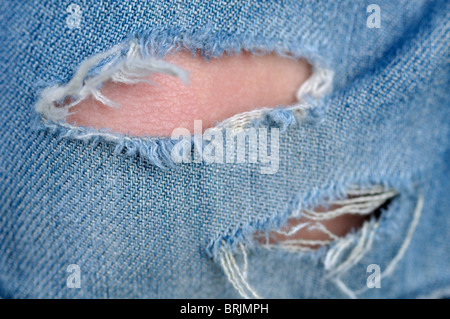 Tear in Blue Jeans Stock Photo