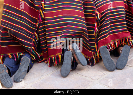 feet of boys at a weaving school in Sucre, Bolivia Stock Photo