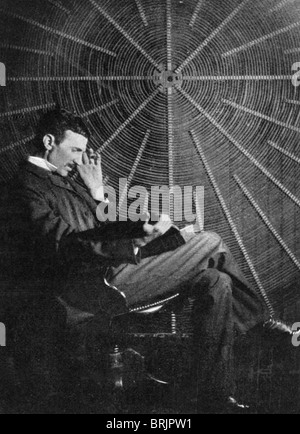 NIKOLA TESLA  (1856-1943) Serbian inventor in front of the spiral coil of his high-frequency transformer - see Description below