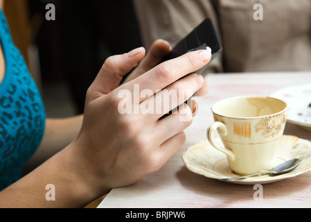 Woman holding cell phone, close-up Stock Photo