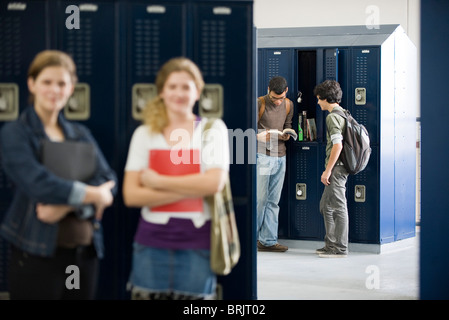 High school students chatting by lockers Stock Photo