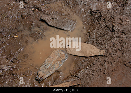 A dirty puddle with litter on a street in Gulu, Northern Uganda Stock Photo