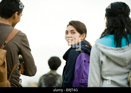 Teenage girl walking with friends Stock Photo