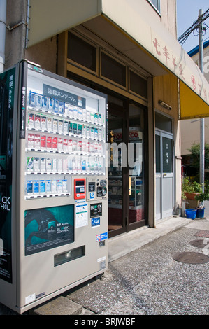 Cigarette vending machine outside a small tobacconist shop. Oita, Kyushu, Japan Stock Photo