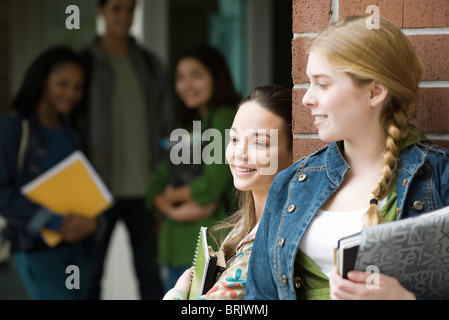 Students chatting together outside school Stock Photo