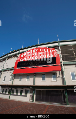 SPORTS Chicago Illinois Night game at Wrigley Field fans in bleachers  traditional scoreboard ivy on outfield wall Stock Photo - Alamy