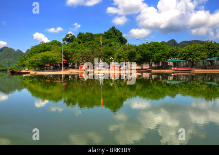 A small village beside a river in Vietnam on the way to the Perfume Pagoda. Stock Photo