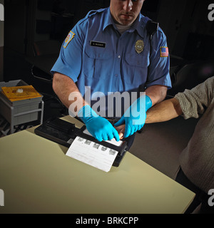 Police officer, security guard, fingerprints criminal suspect prisoner. Stock Photo