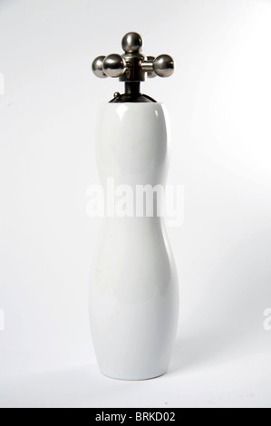 A ceramic pepper grinder with a chrome handle. Stock Photo