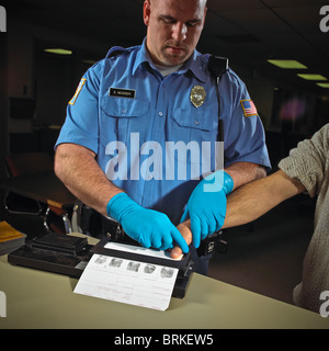Police officer, security guard, fingerprints criminal suspect prisoner. Stock Photo