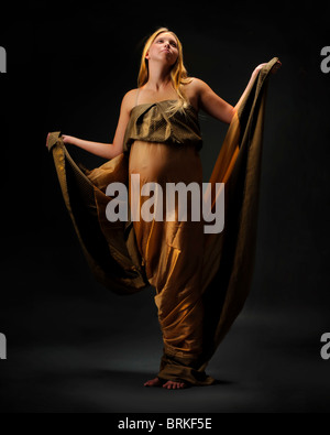 Pregnant woman goddess posing in studio Stock Photo