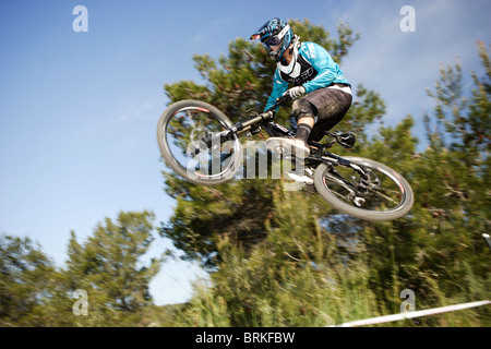 Professional Mountain Biker Aaron Gwin getting air on the Downhill Course at the 2010 Sea Otter Classic. Stock Photo