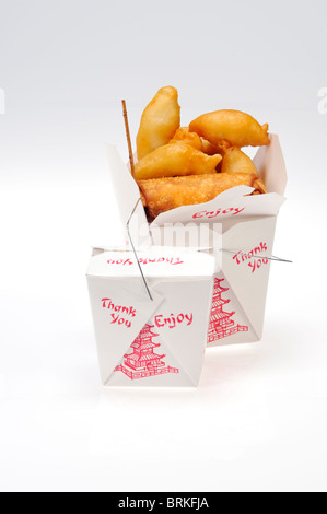 2 take away food containers of chinese food 1 open with chicken fingers, eggroll and beef teriyaki 1 closed on white background. Stock Photo