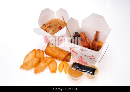 Chinese food take away meal boxes of pork fried rice, chicken fingers & wings, egg roll & beef teriyaki with dip & soy sauce. Stock Photo