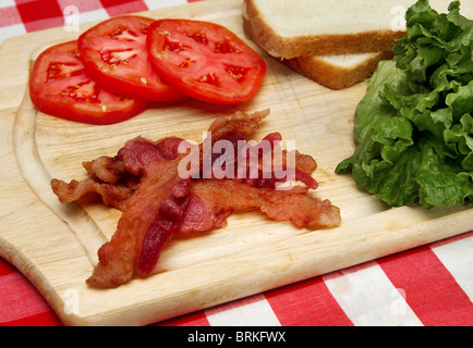 blt ingredients bacon lettuce tomato on a cutting board Stock Photo