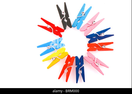 colorful clothes pins in circle pattern isolated over white Stock Photo