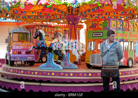 Carnie at merry-go-round - Abingdon Fair in Oxfordshire Stock Photo