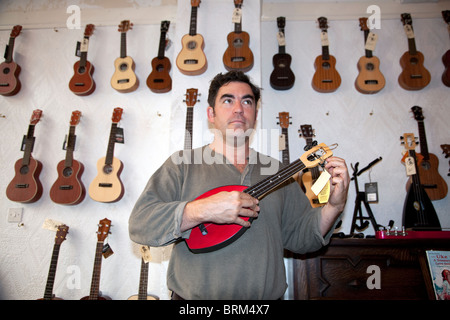 Matthew Reynolds of the Duke of Uke ukulele shop in Hanbury Street, Brick Lane, London Stock Photo