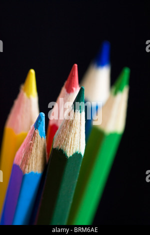 Color pencils on black background. Selective focus. Stock Photo