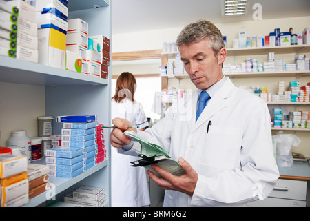 Pharmacist looking at prescription Stock Photo