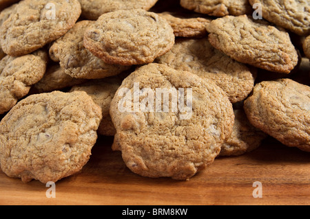 small stack of gluten free chocolate chip cookies on a wooden cutting board Stock Photo