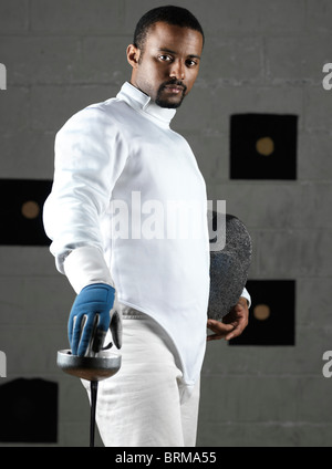 Portrait of a fencer wearing fencing uniform in a gym Stock Photo