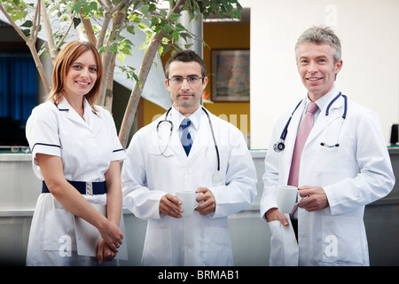 Doctors and nurse in waiting area Stock Photo