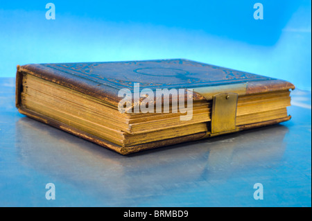 big old book symbol symbolic blue background gold golden ancient bible diary  studio shot bright antique antiquariat snap heavy Stock Photo
