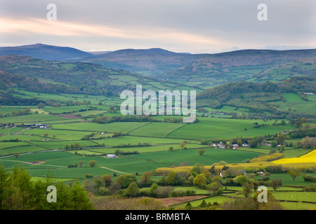 Rolling farmland looking westwards towards Sugarloaf mountain from Ysgyryd Fawr mountain, Abergavenny, Monmouthshire, Wales. Stock Photo
