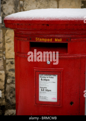 Closeup of a Royail Mail red post box covered in snow, UK Stock Photo