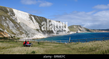 Hikers resting on the Jurassic Coastal Path, Dorset, England
