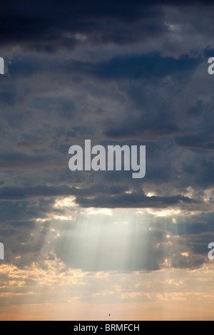 Sun shining through dark clouds , Finland Stock Photo