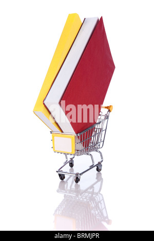 Stack of color books and a shopping cart (isolated on white) Stock Photo