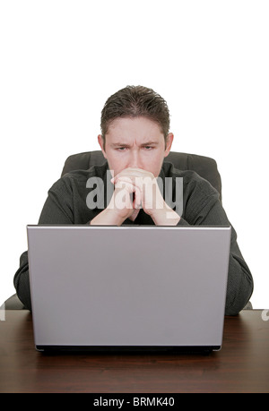 caucasian guy working on a laptop staring and concentrating Stock Photo