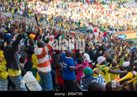 Soccer supporters doing the Mexican wave during the 2010 World Cup match between Korean DPR and Cote d'Ivoire Stock Photo