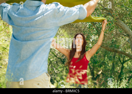 Couple laying out picnic blanket Stock Photo