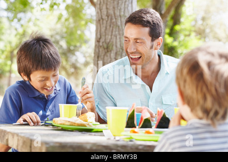 Happy father with 2 boys having a picnic Stock Photo