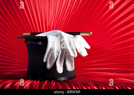 Magician's Top Hat, Wand and Gloves on Red Curtain Stock Photo