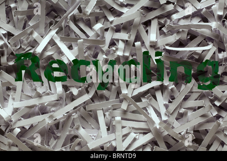 close up detail image of shredded paper with the words recycling printed on it Stock Photo