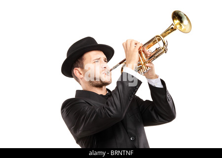 A man in a suit with a hat playing a trumpet Stock Photo