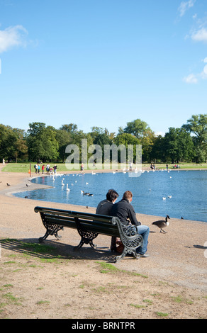 young couple sitting on the bench Stock Photo - Alamy