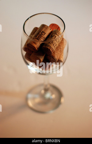 Corks all piled together in a wine glass, the glass is full Stock Photo