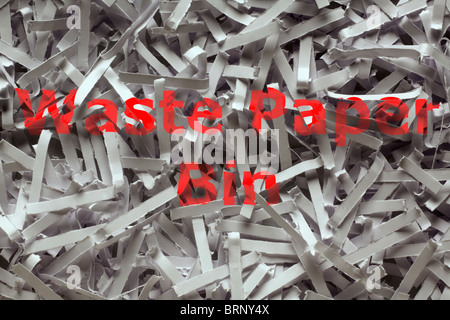 close up detail image of shredded paper with the words waste paper bin printed on it Stock Photo