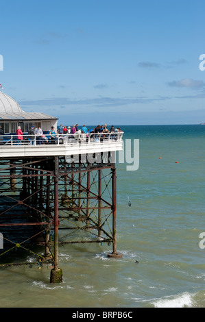 Holidaymakers crabbing and fishing at the end of Cromer pier on a summer day in Norfolk, East Anglia, England. Stock Photo