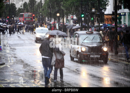 Oxford Street Shoppers on a cold and rainy day. Stock Photo