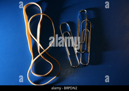 rubber bands, one in a figure of eight and paper clips Stock Photo