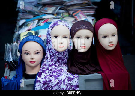 Head scarves for sale at a stall selling clothes for Muslims on Whitechapel Market in the East End of London. Stock Photo