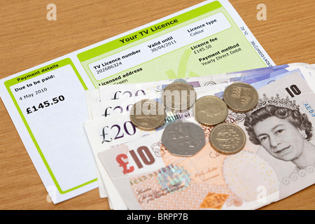 TV licence with cash to pay for it Stock Photo